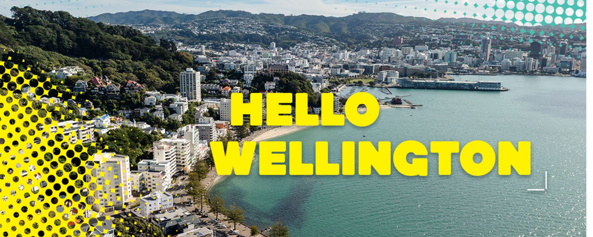 Aerial view of Wellington harbour with “Hello Wellington” text and Victoria University of Wellington branding.