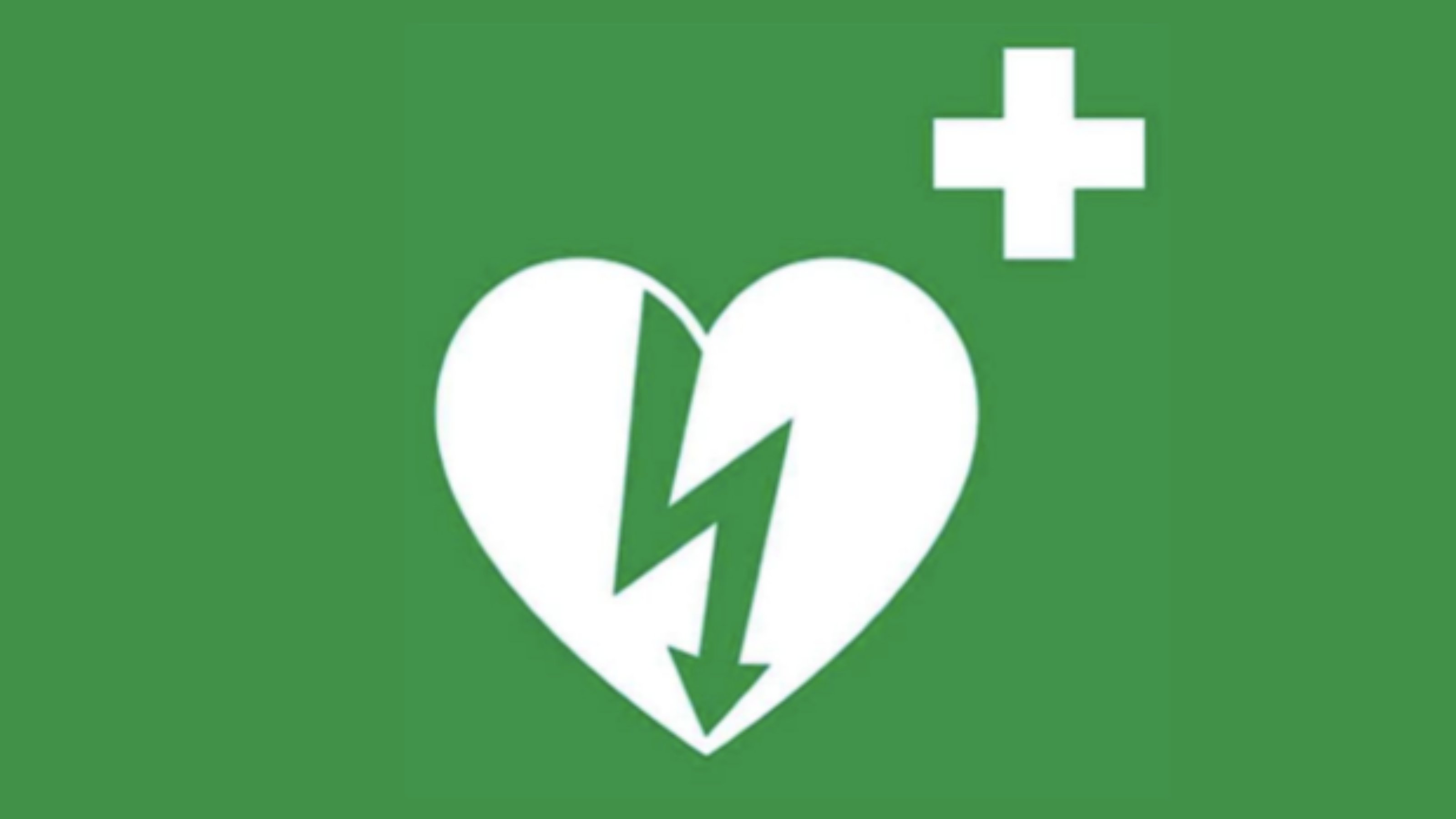 Universal AED sign. A heart with an arrow and shock symbol through it, with a white cross in the corner on a green background.