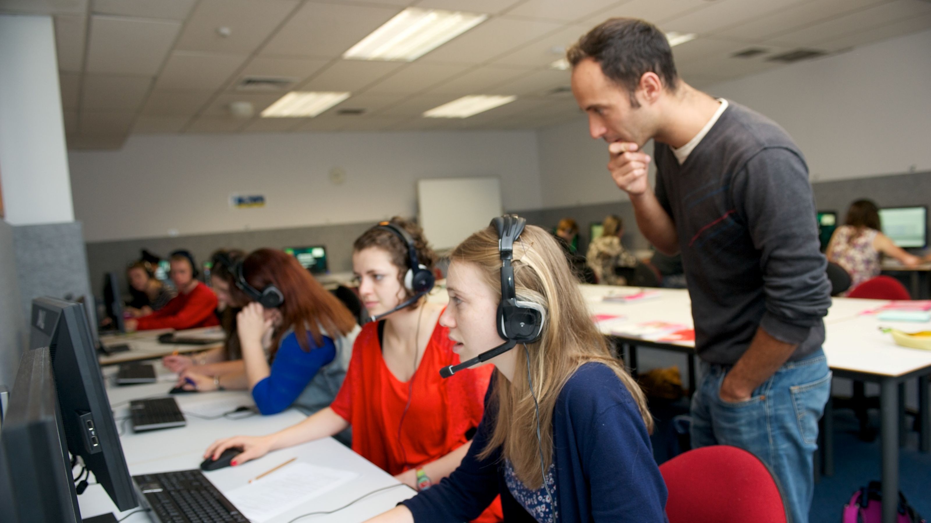 School of Languages and Cultures tutor Luc Arnault guiding students during a tutorial in one of the Language Learning Centre's teaching labs.