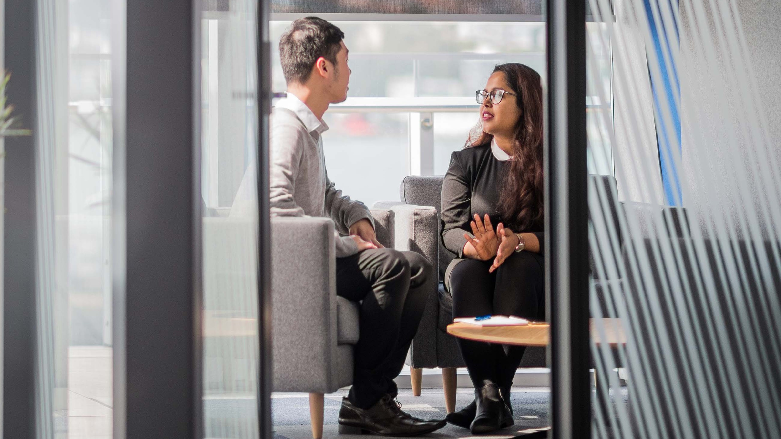 A man and woman have discussion at table