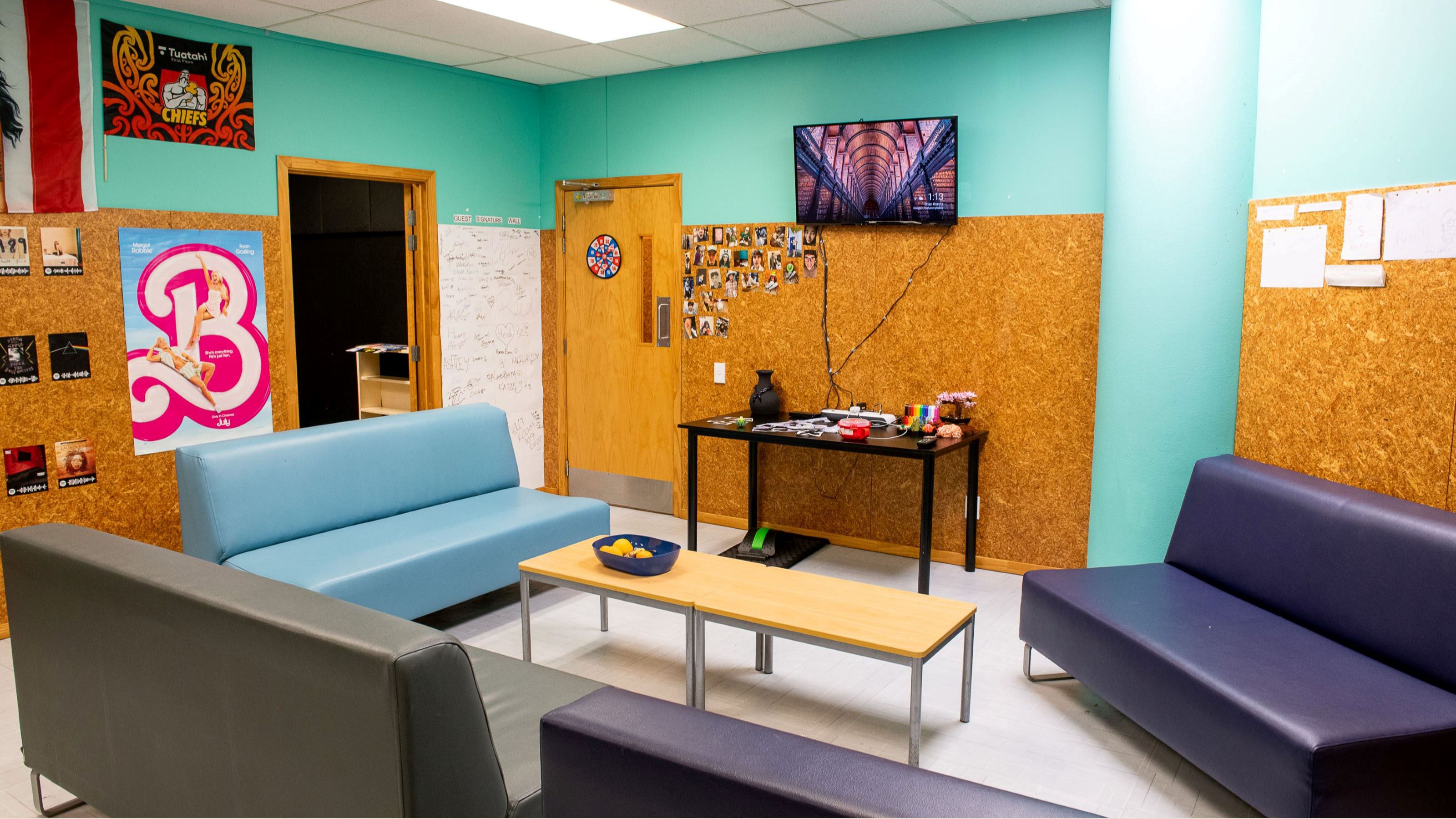 Common space with couches and TV at Joan Stevens Hall.