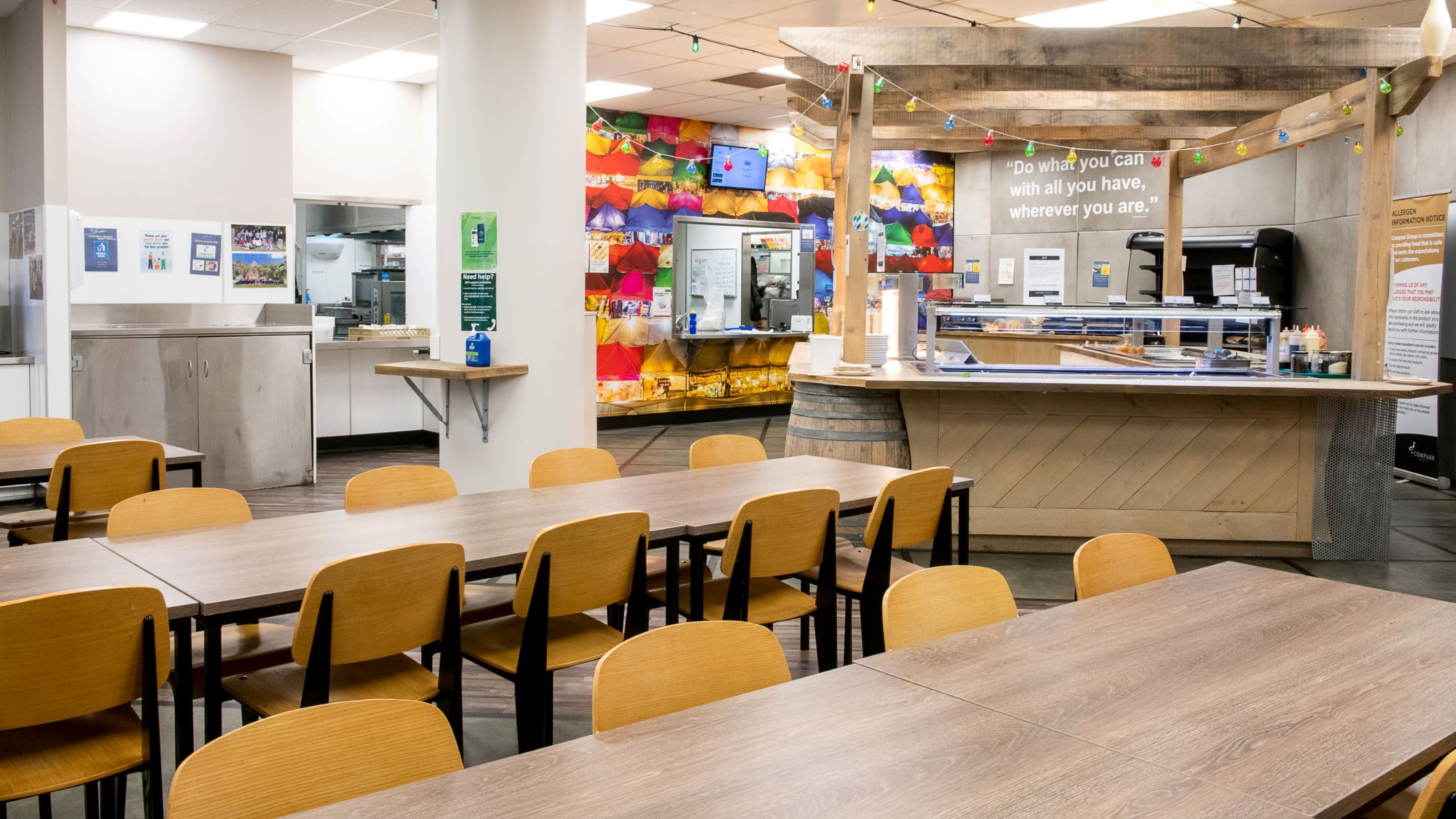 Long tables in the dining room at Joan Stevens Hall, with a self-sevice food station.