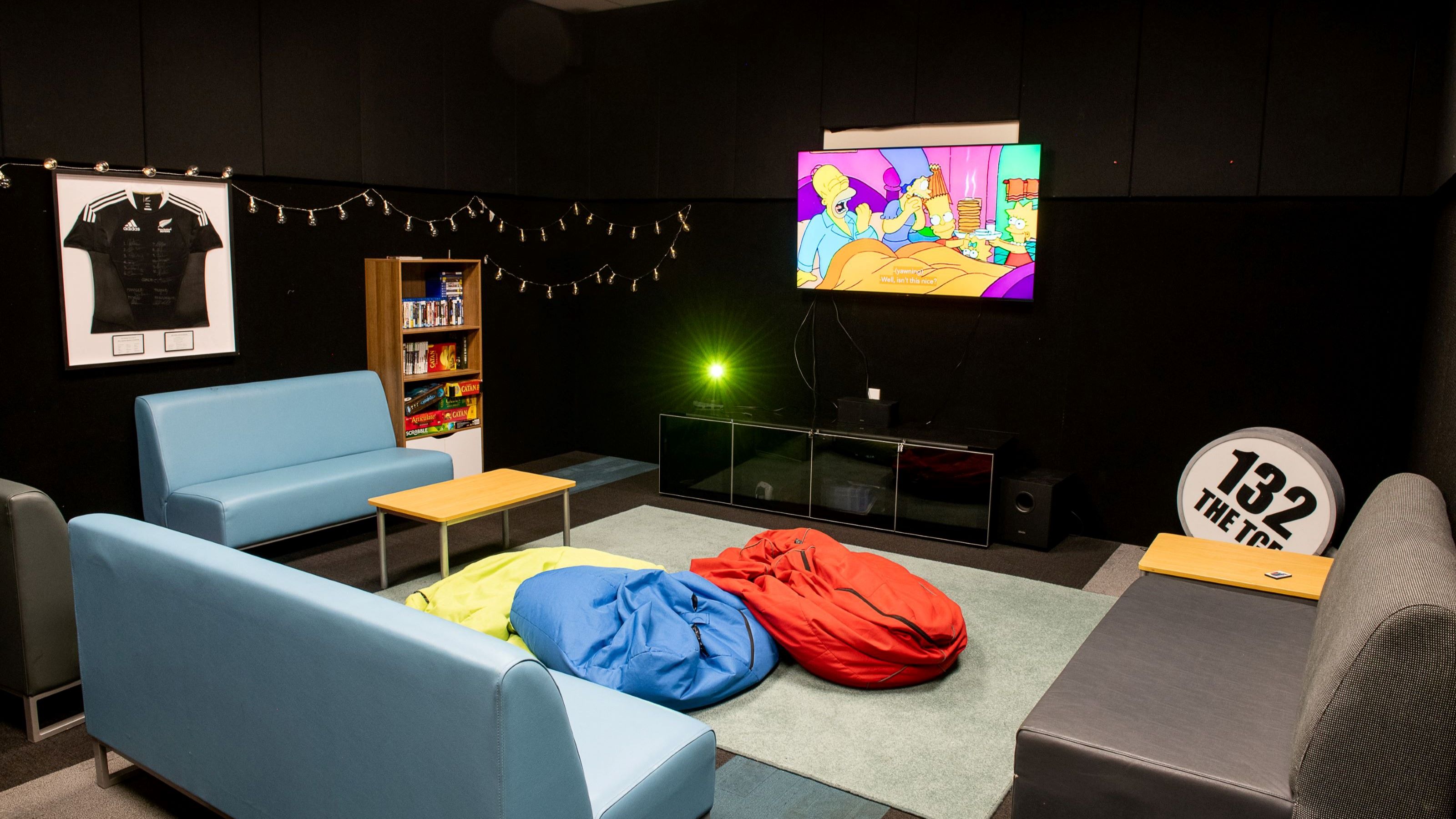 TV room at Joan Stevens Hall, with couches, bean bags, and a television.