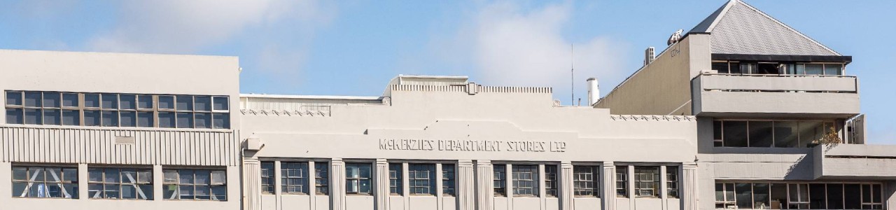 The frontage of a building, reading "McKenzie's Department Stores Limited".