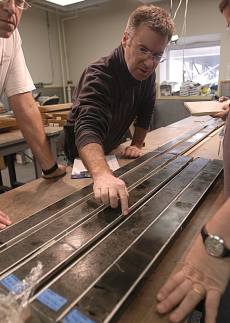 Researchers with sediment core samples.