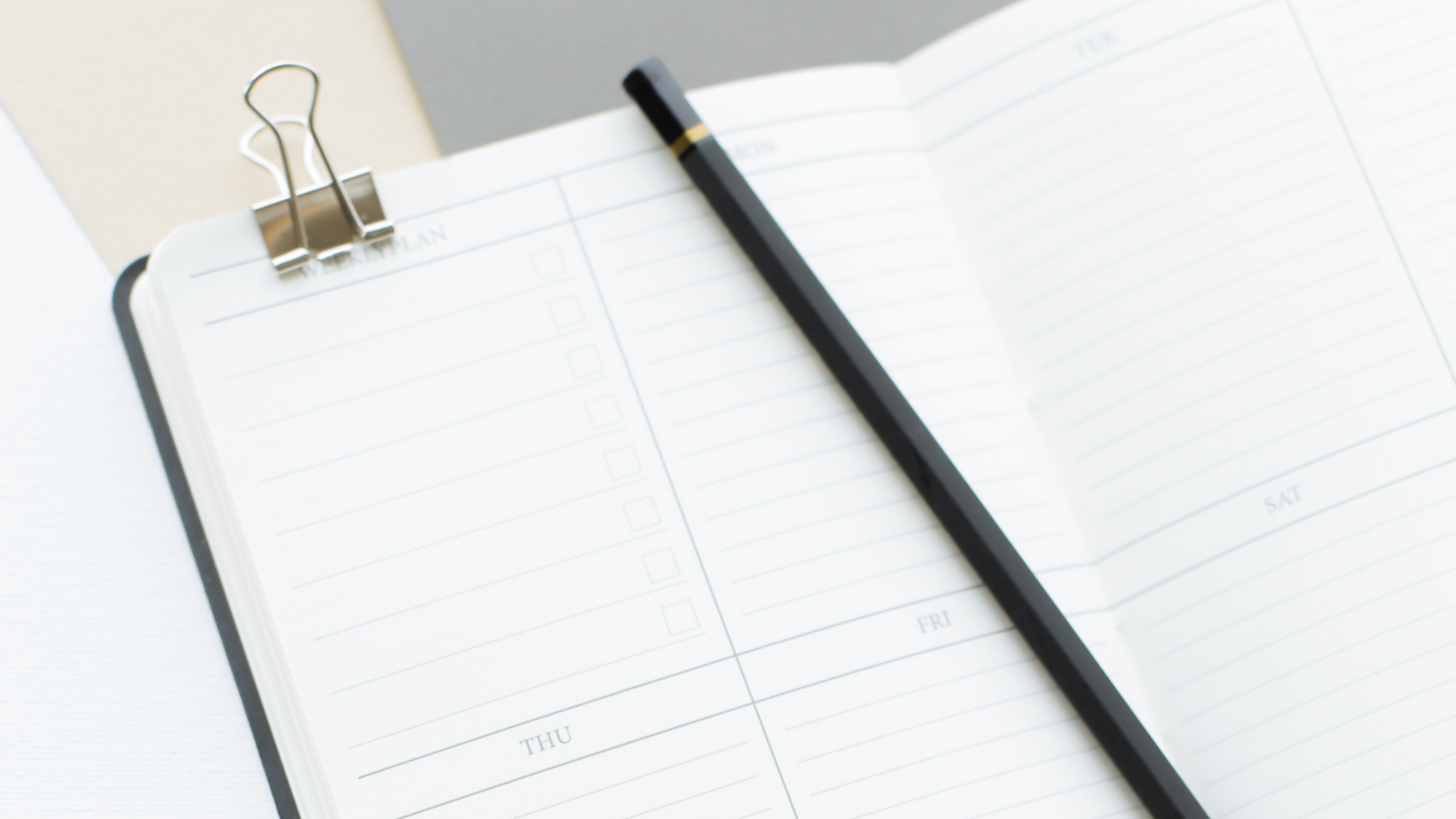 Opened diary with pencil placed on top