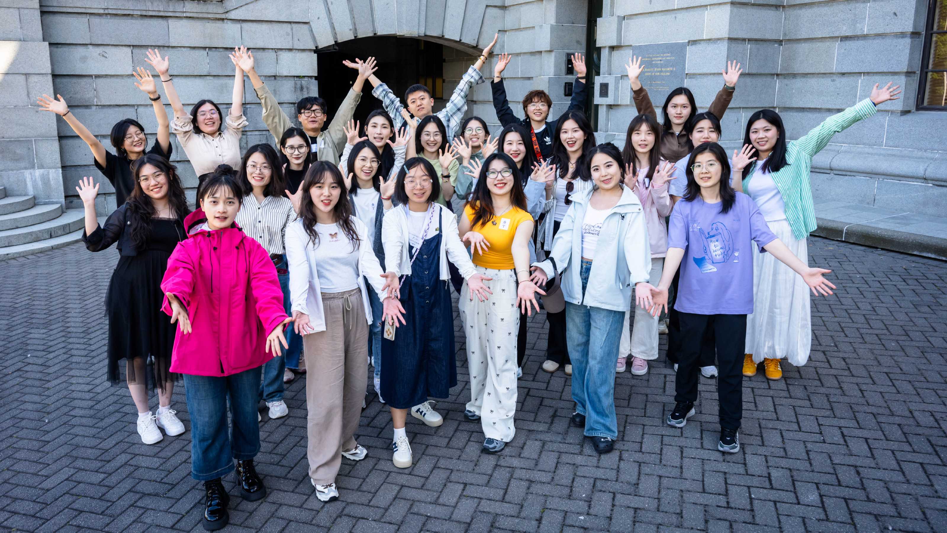 A large group of Mandarin Language Assistants posed for the camera outside the steps of Wellington's Parliament buildings.