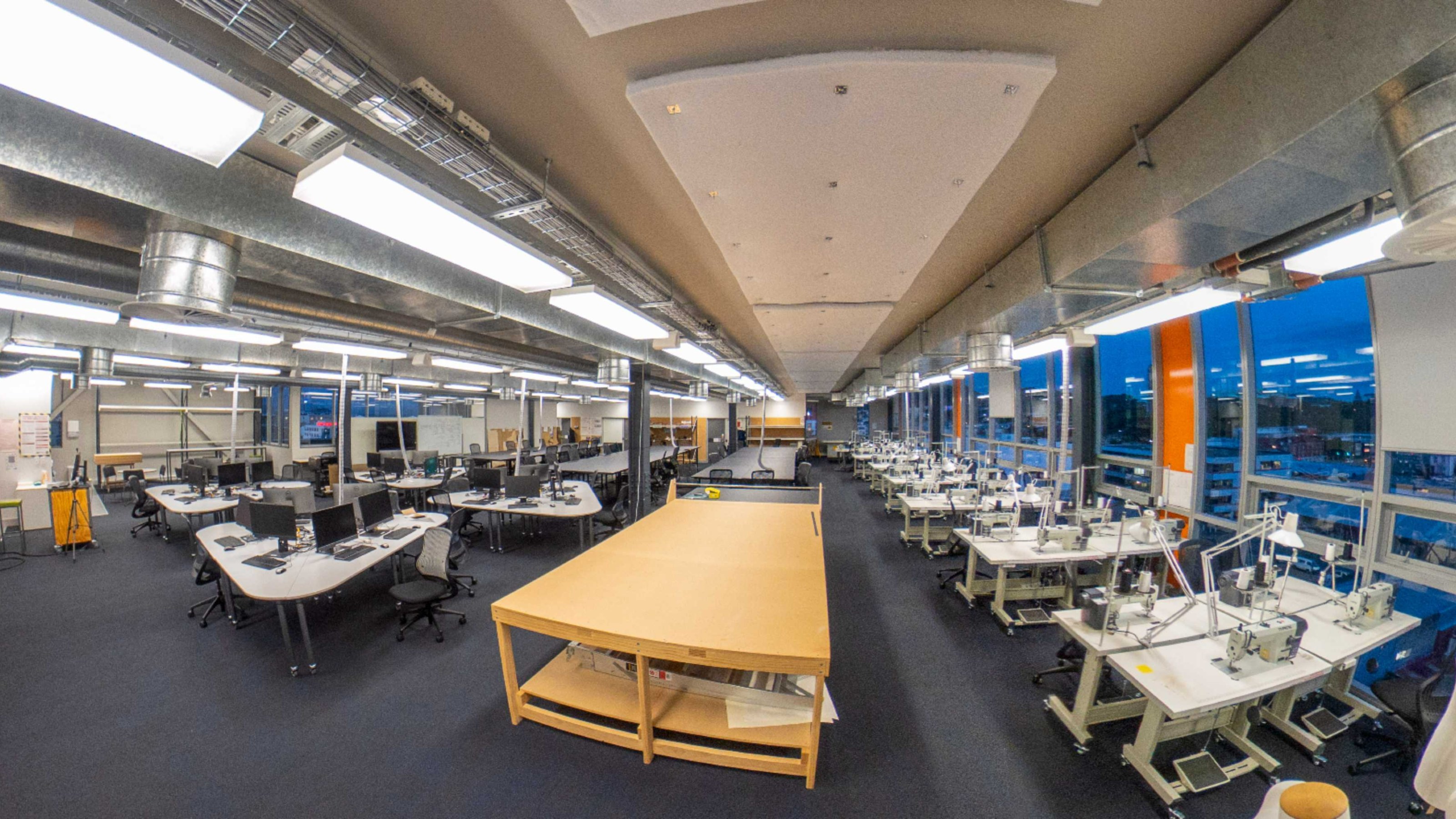 Large modern classroom filled with sewing machines