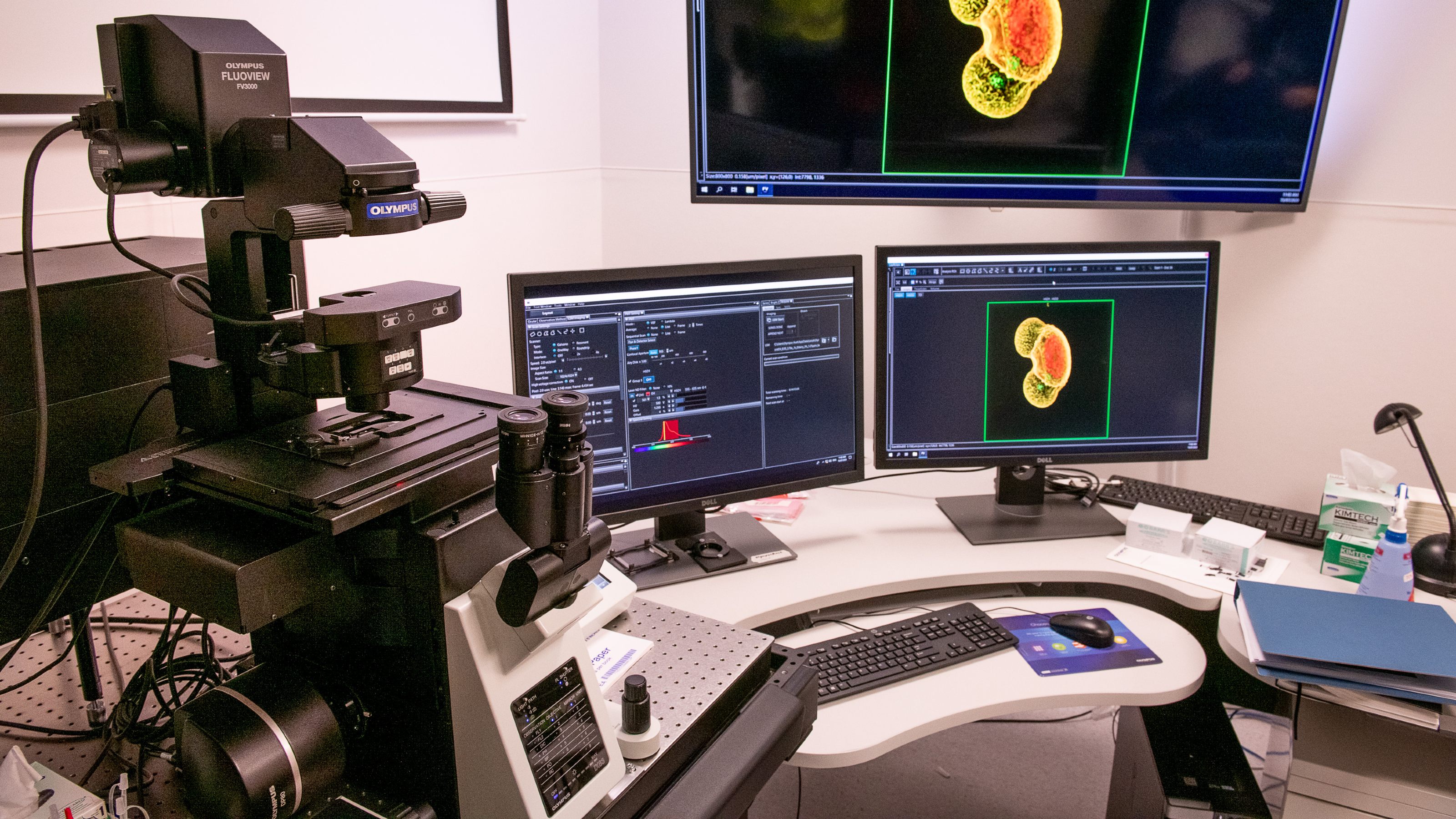 Large electronic microscope and three computer screens