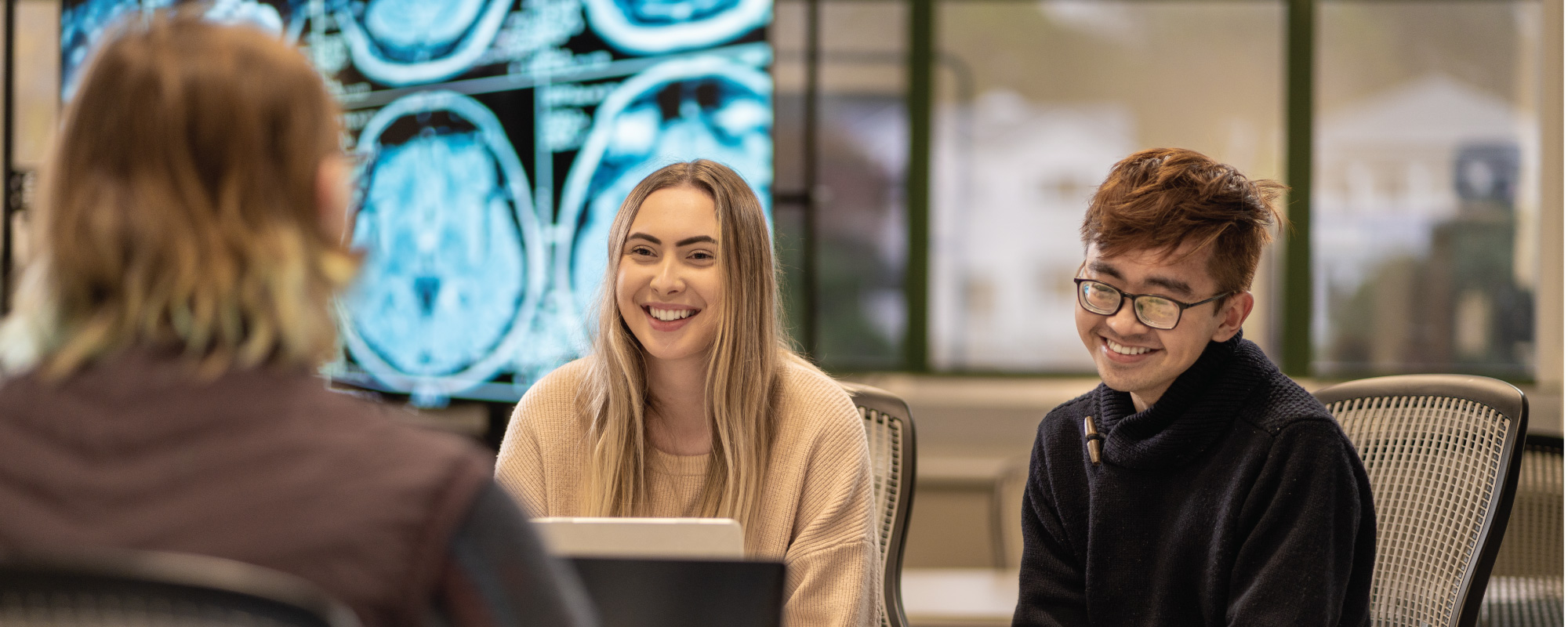 Group of students with brain scans in background
