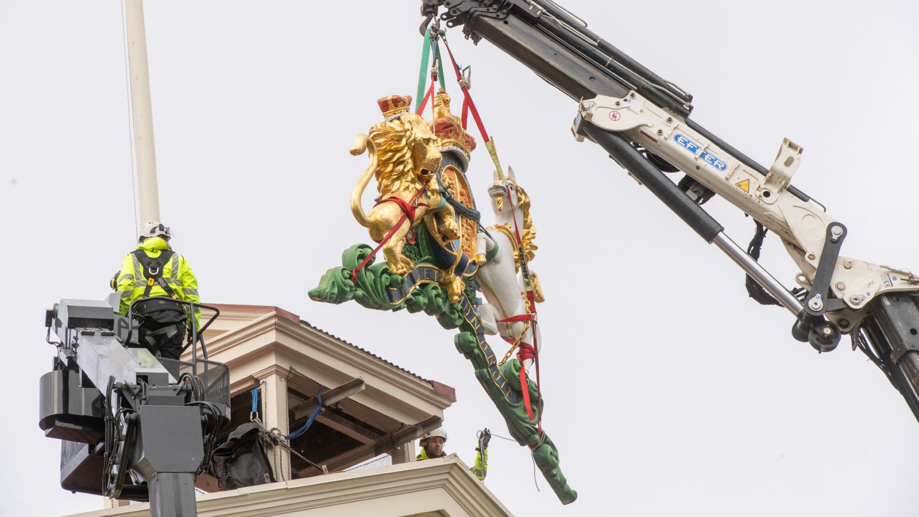 Crane lifts object off building