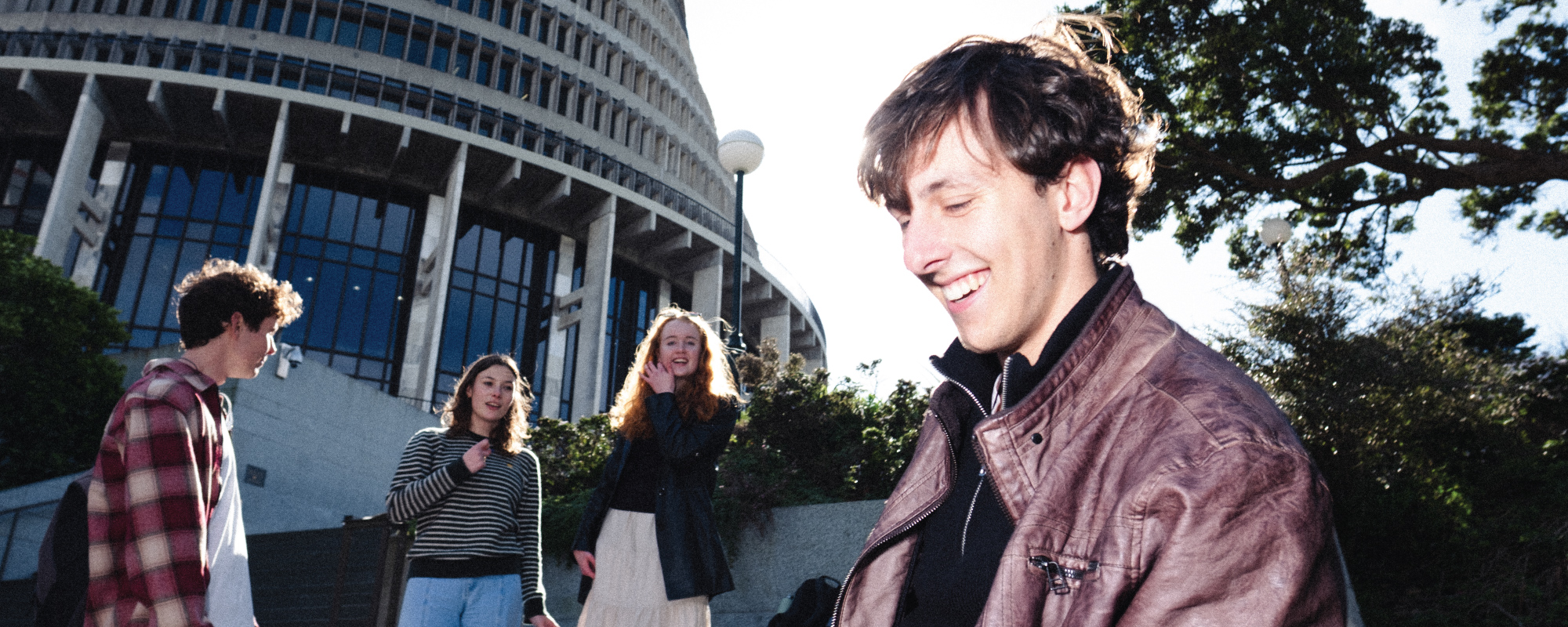 Four students spending time together in front of Beehive.