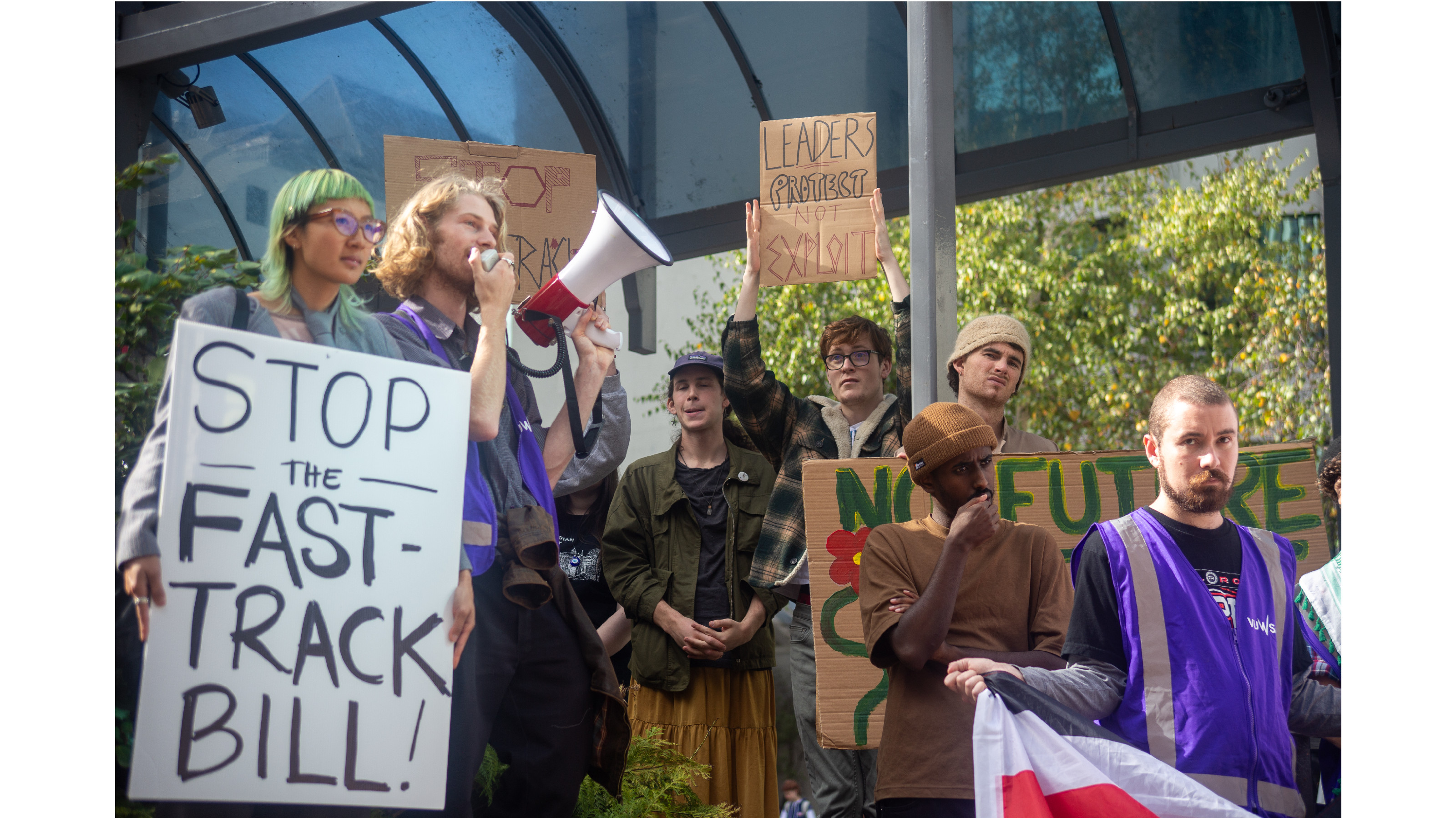 A group of protesters, a placard reads "Stop the fast-track bill".
