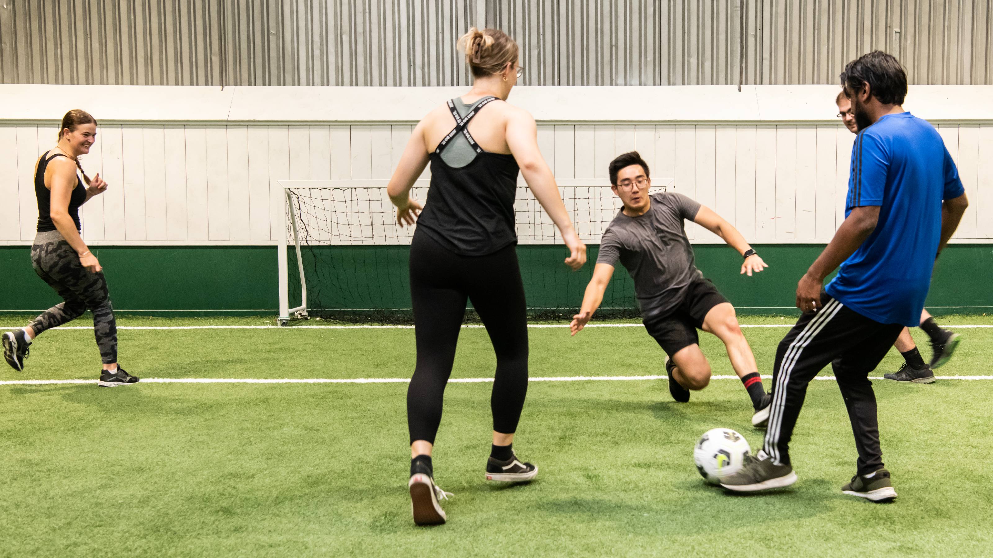 Four people playing indoor football