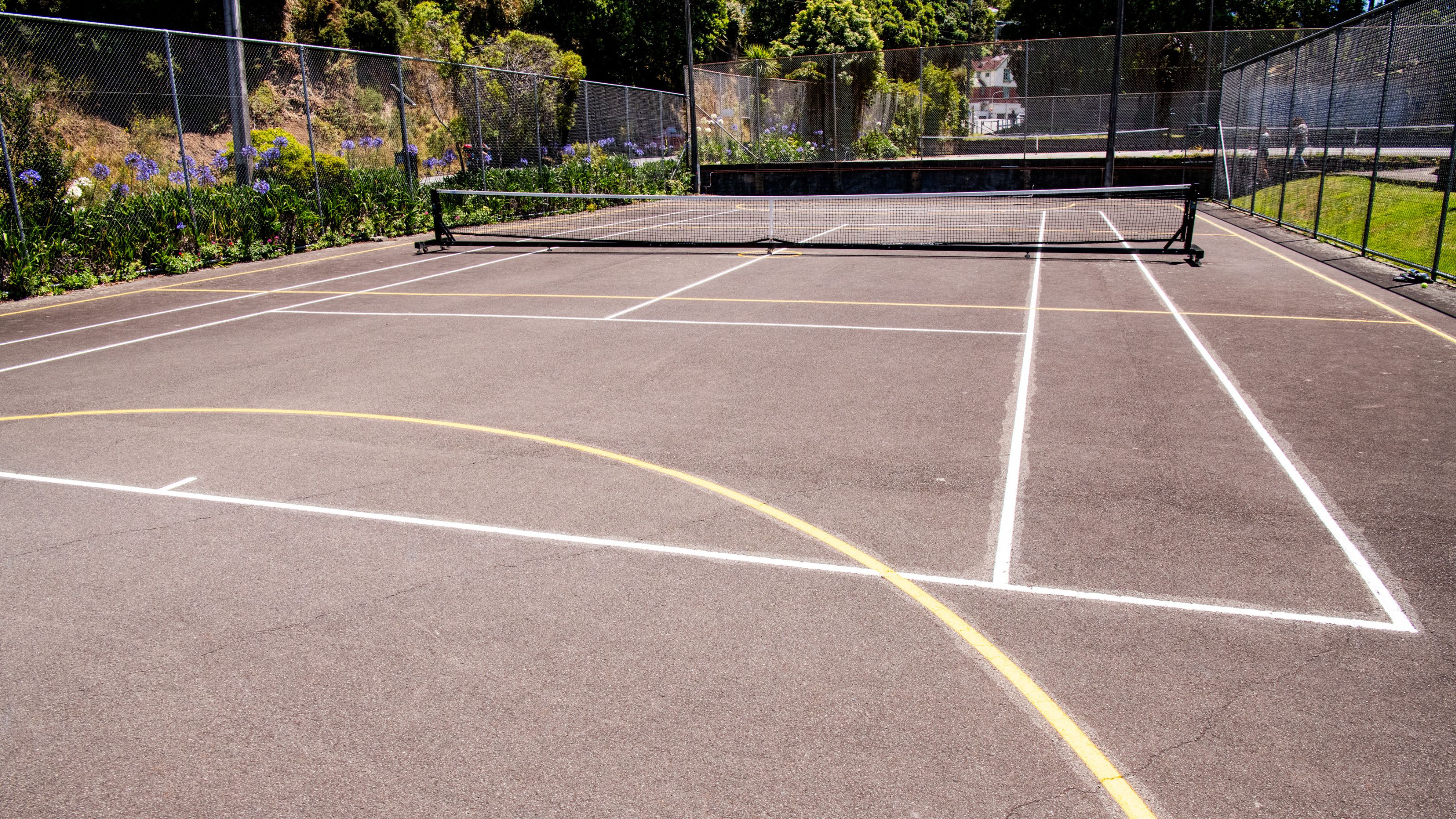 A photo of a tennis court on a sunny day