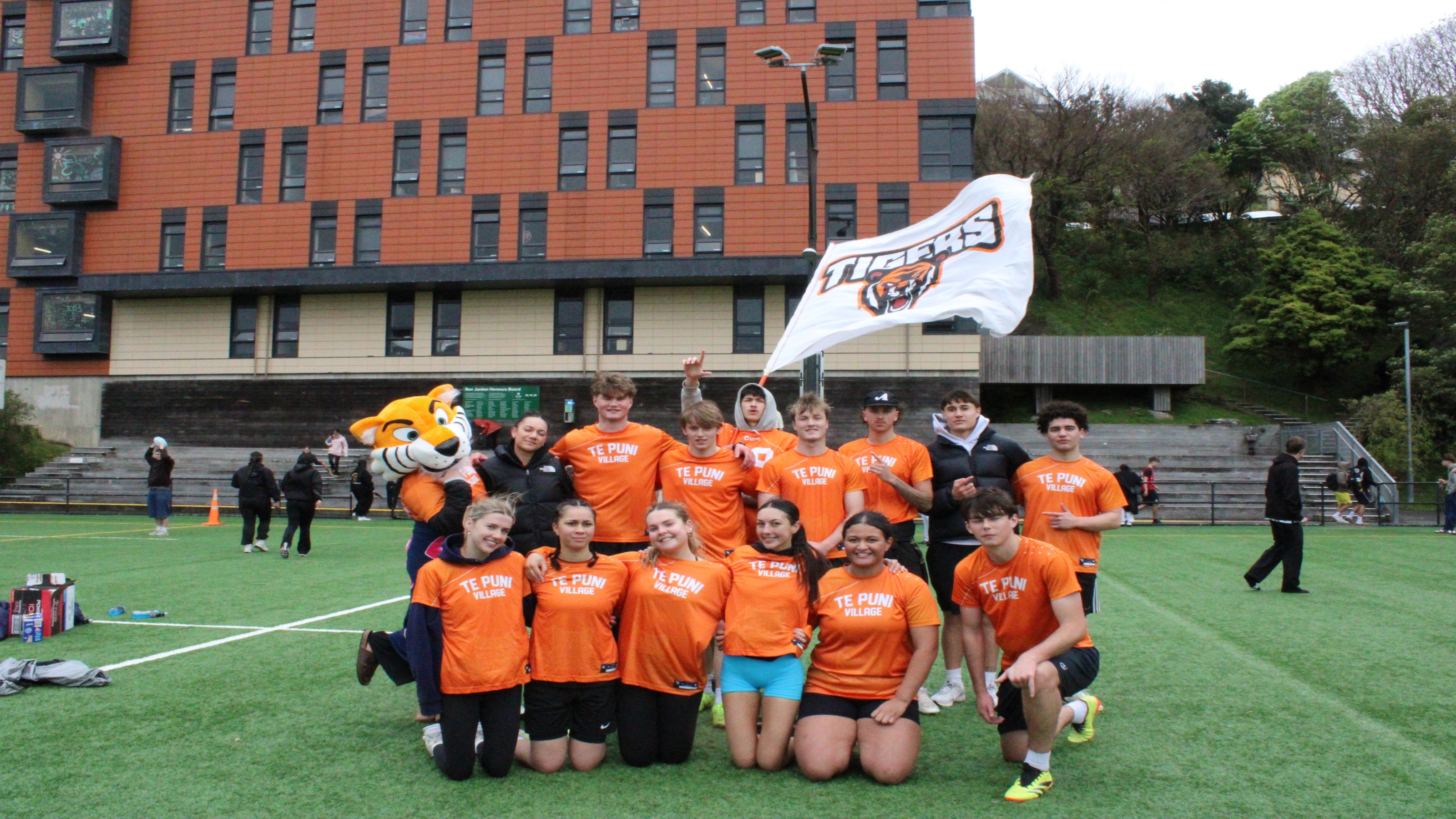 Group of TPV students posing on Boyd-Wilson Field after a halls sport event