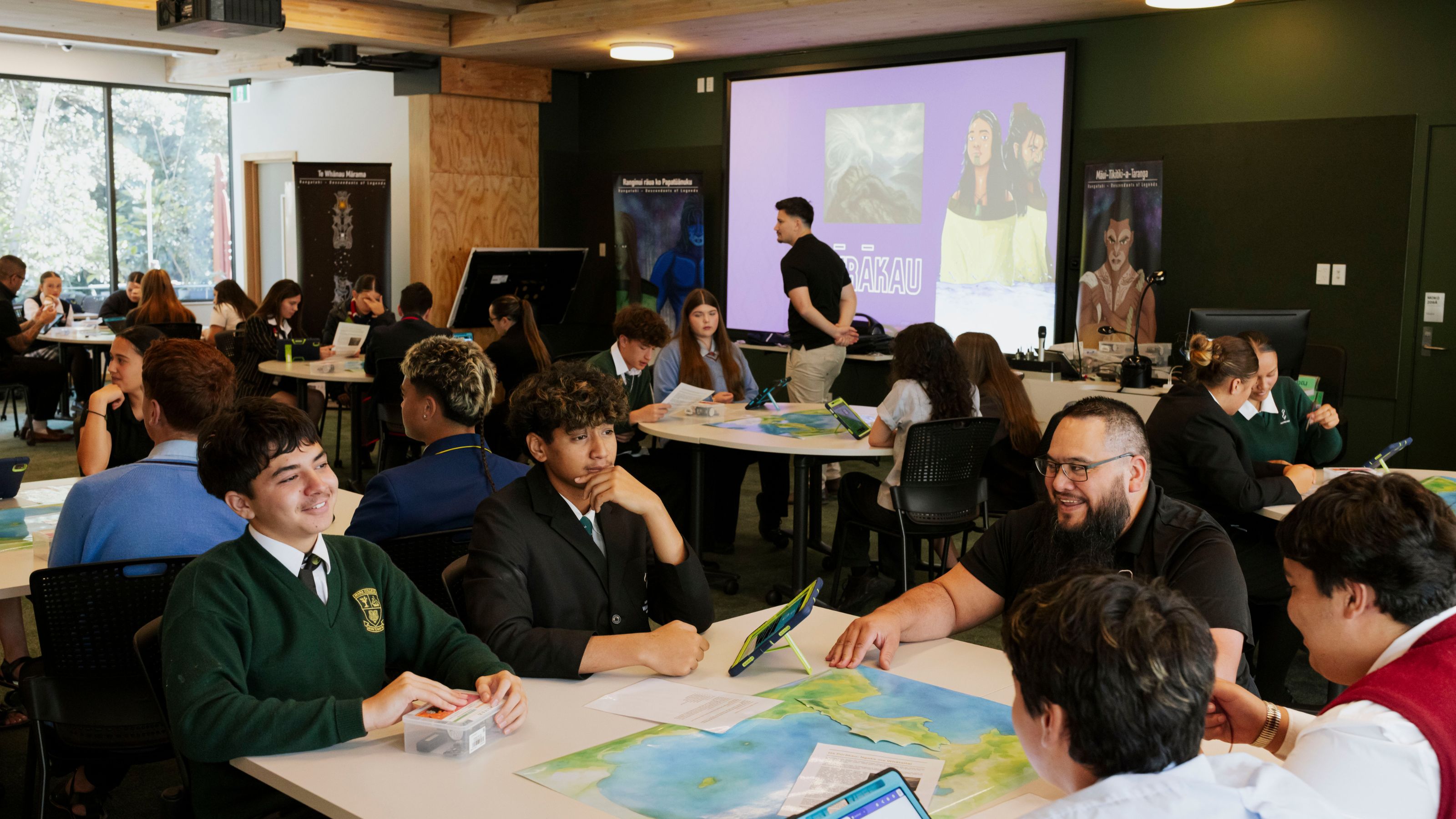 Students grouped around tables with activities on them