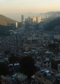 An image of slums in a valley.